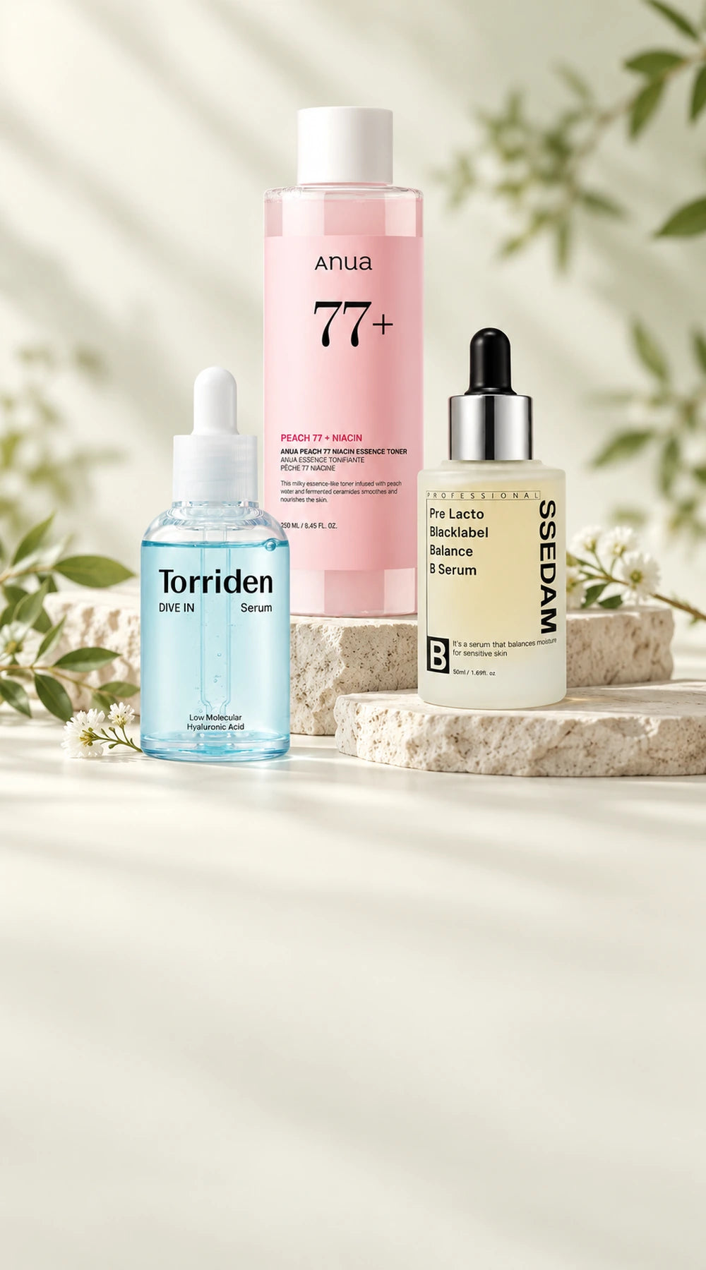 Anua Peach toner, Torriden DIVE IN serum and SSEDAM serum on pale stone display stands